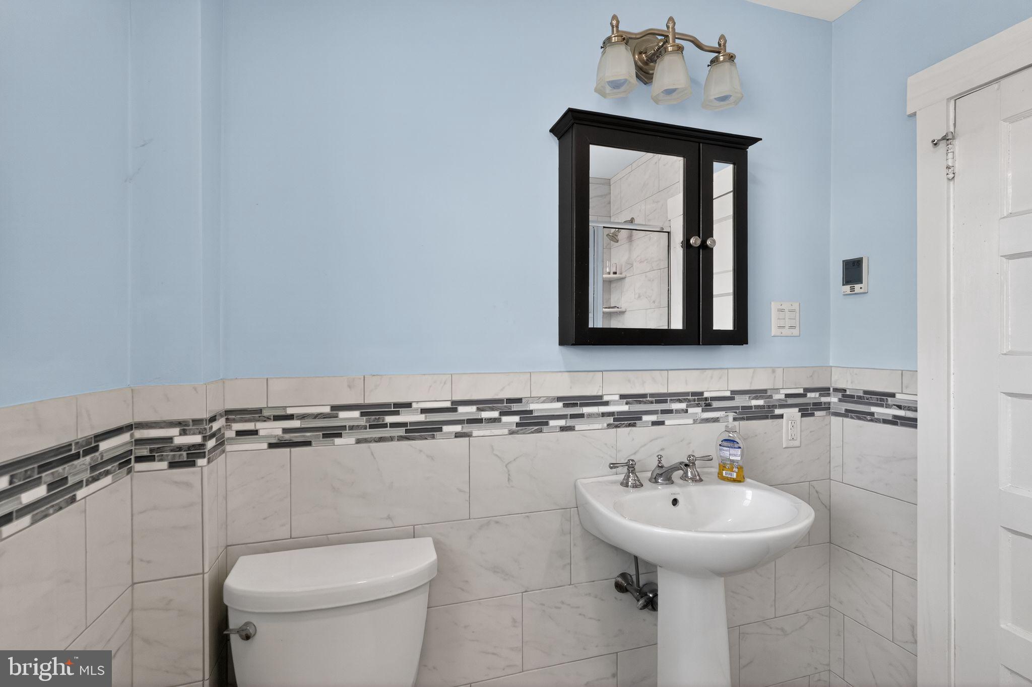 633 Dayton Road Bryn Mawr, PA 19010 - Photo 11 of 18 a bathroom with a toilet sink and mirror