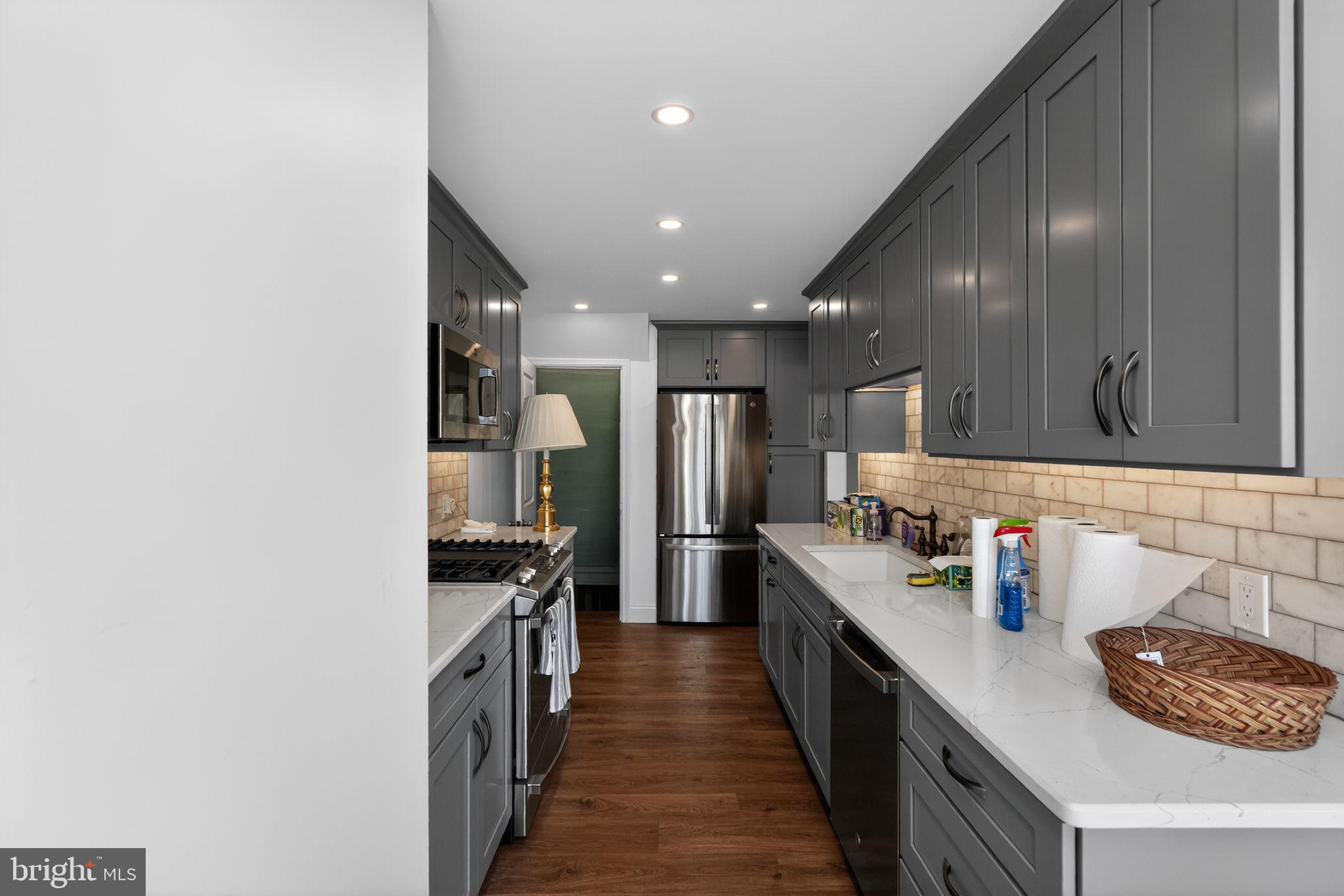 633 Dayton Road Bryn Mawr, PA 19010 - Photo 4 of 18 a kitchen with stainless steel appliances a sink and stove