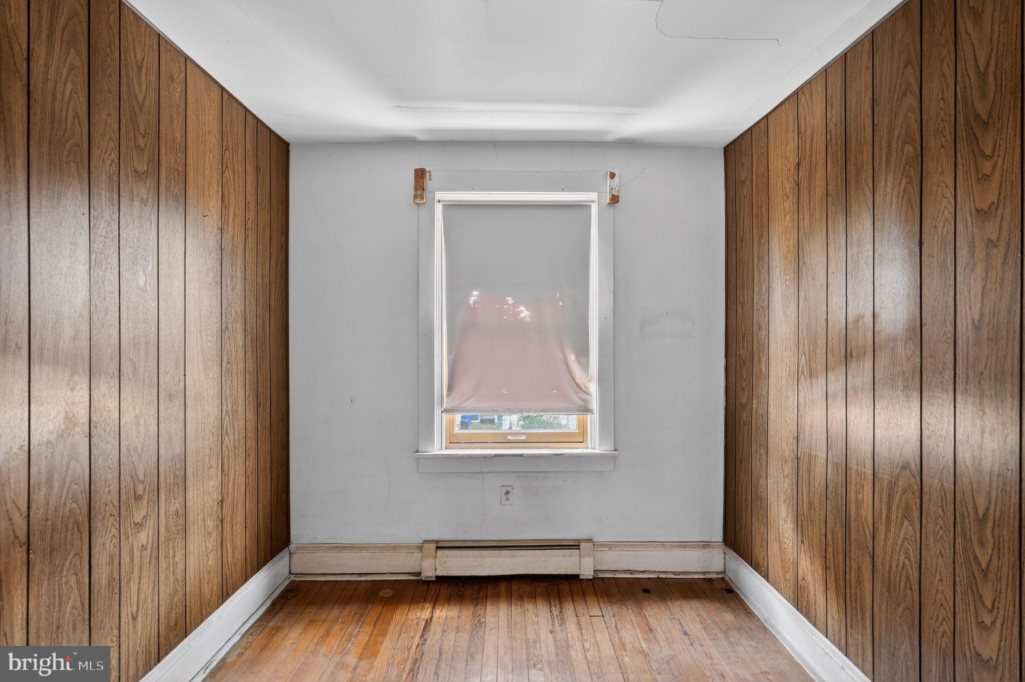633 Dayton Road Bryn Mawr, PA 19010 - Photo 9 of 18 an empty room with wooden floor and windows