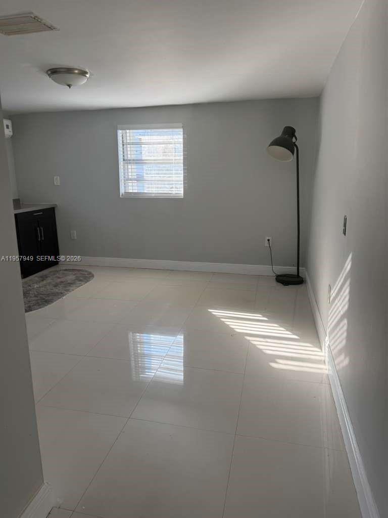 3100 Northwest 91st Street, Unit 3100 Miami, FL 33147 - Photo 2 of 5 a view of empty room with window