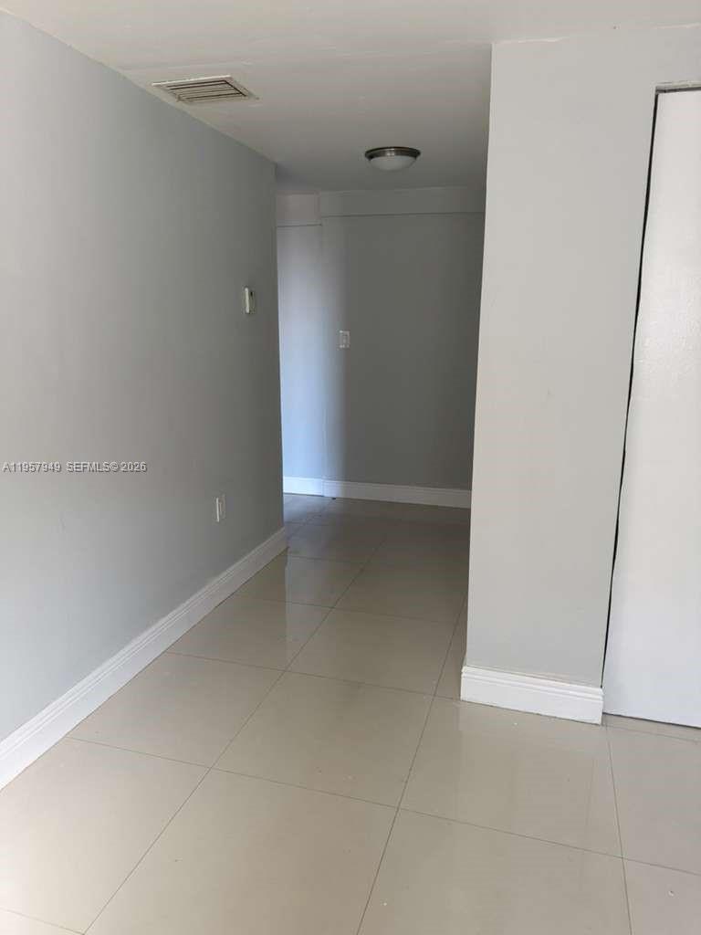 3100 Northwest 91st Street, Unit 3100 Miami, FL 33147 - Photo 3 of 5 a view of an empty room