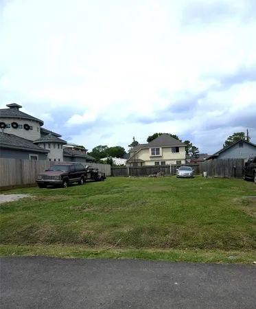 a view of a big house with a big yard and large trees