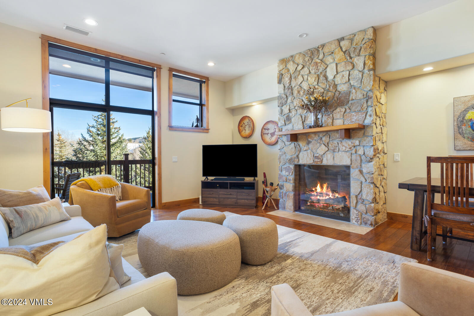 a living room with furniture a flat screen tv and a fireplace