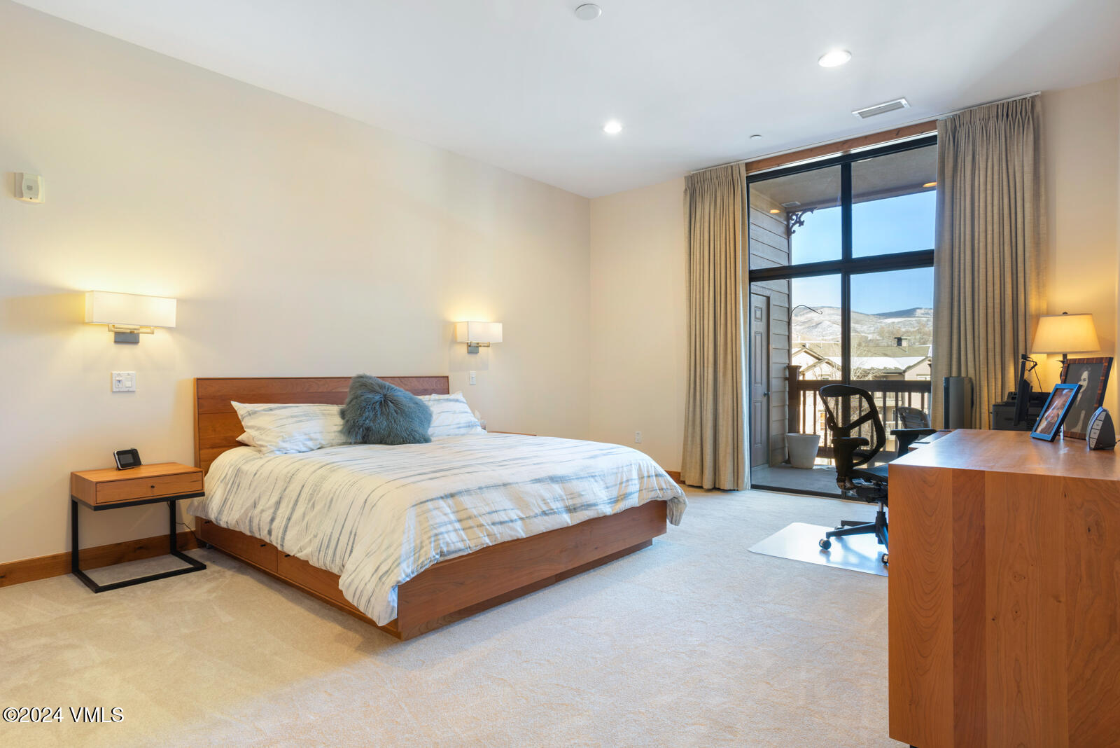 295 Main Street, Unit R202 Edwards, CO 81632 - Photo 13 of 26 a spacious bedroom with a bed and a large window