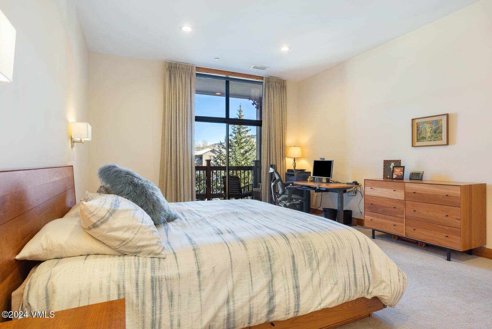 295 Main Street, Unit R202 Edwards, CO 81632 - Photo 14 of 26 a bedroom with a bed and a large window