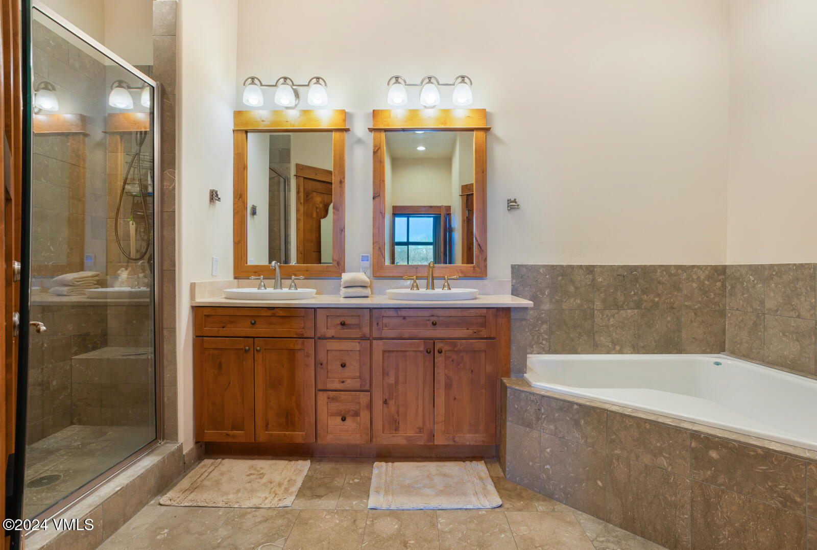 295 Main Street, Unit R202 Edwards, CO 81632 - Photo 15 of 26 a bathroom with a bathtub a double vanity sink and a mirror
