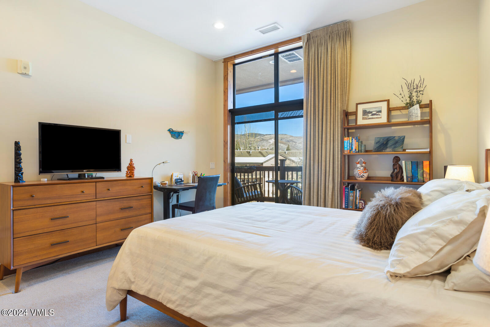 295 Main Street, Unit R202 Edwards, CO 81632 - Photo 17 of 26 a bedroom with a bed and a flat screen tv