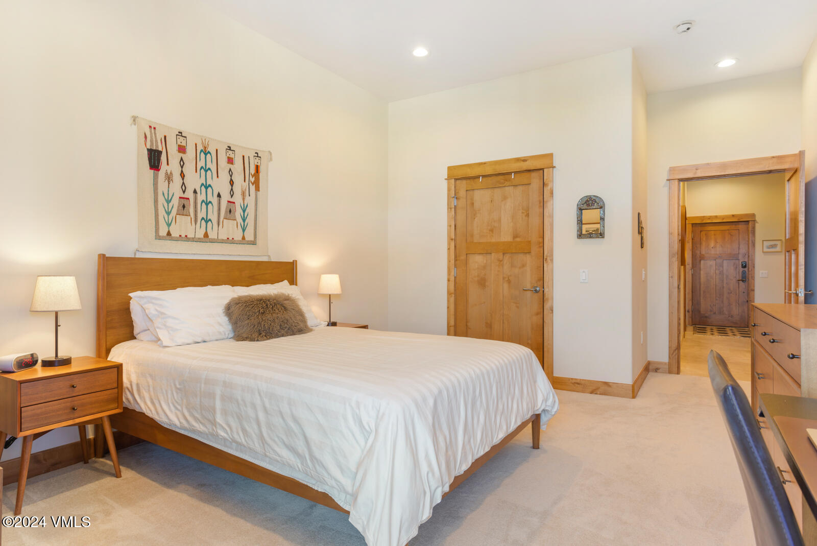 295 Main Street, Unit R202 Edwards, CO 81632 - Photo 18 of 26 a bedroom with a bed and a lamp with table