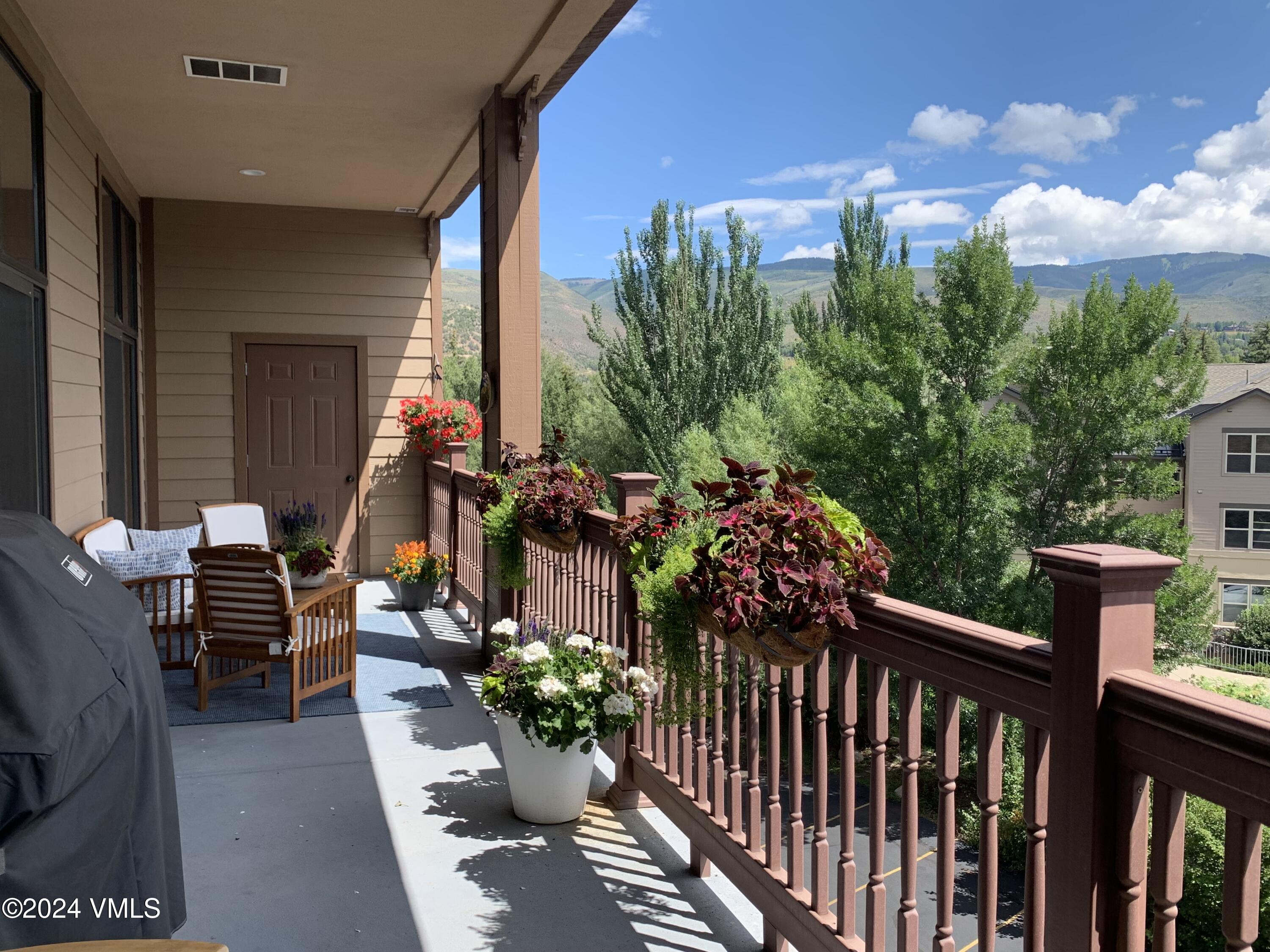 295 Main Street, Unit R202 Edwards, CO 81632 - Photo 23 of 26 a view of a patio with table and chairs and potted plants