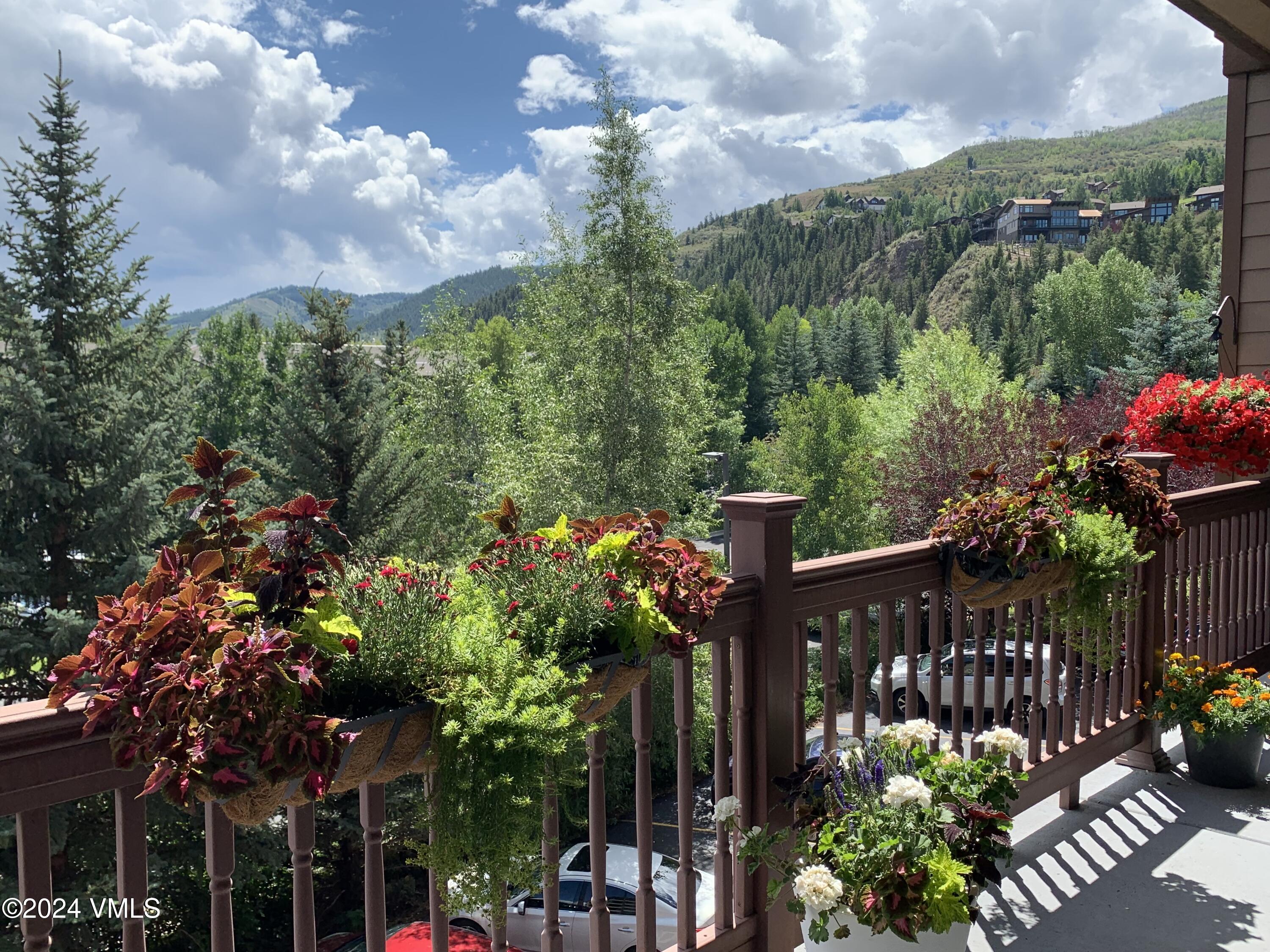 295 Main Street, Unit R202 Edwards, CO 81632 - Photo 24 of 26 a front view of a house with a flower garden