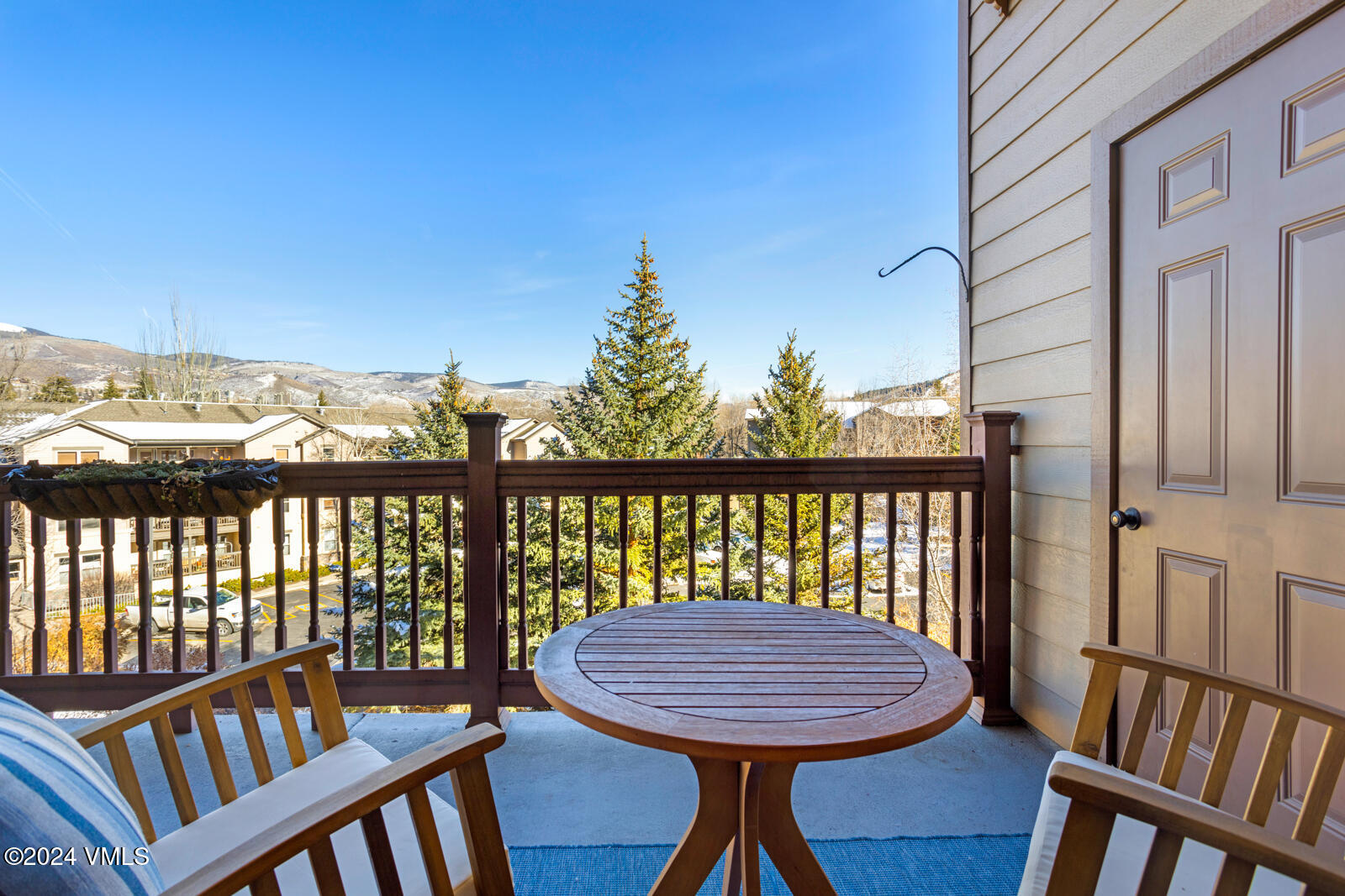 295 Main Street, Unit R202 Edwards, CO 81632 - Photo 8 of 26 a view of a balcony with wooden chairs