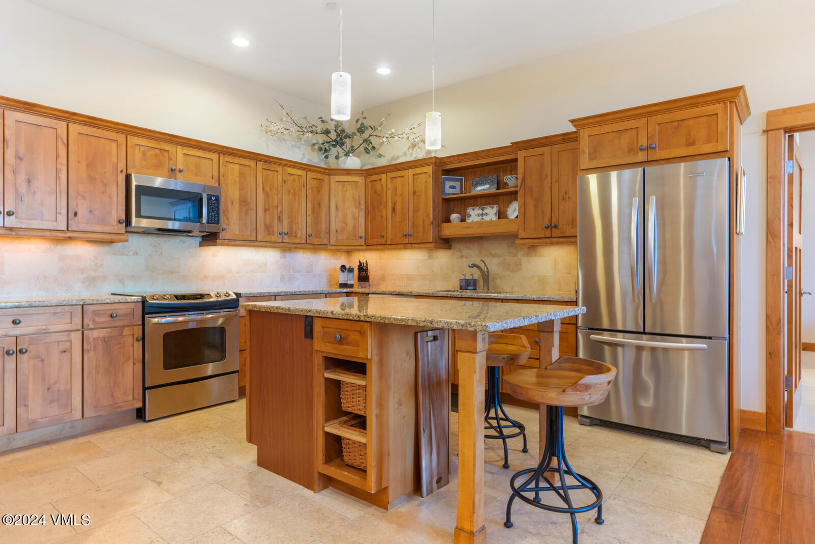 295 Main Street, Unit R202 Edwards, CO 81632 - Photo 9 of 26 a kitchen with stainless steel appliances granite countertop a refrigerator a stove top oven a sink and dishwasher