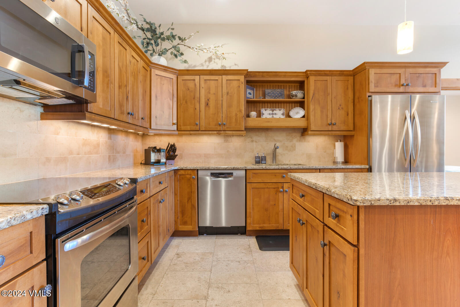 295 Main Street, Unit R202 Edwards, CO 81632 - Photo 10 of 26 a kitchen with stainless steel appliances granite countertop a sink stove and refrigerator
