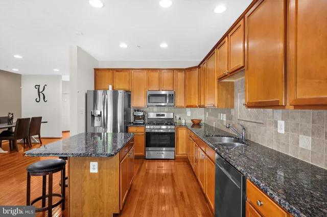 a kitchen with stainless steel appliances granite countertop counter space a sink and cabinets