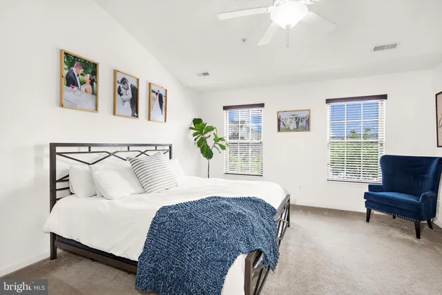 a spacious bedroom with a bed a couch and a window