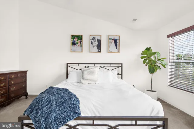 a bedroom with a bed and a window