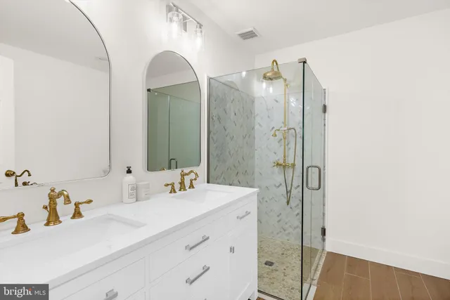 a bathroom with a double vanity sink mirror and double