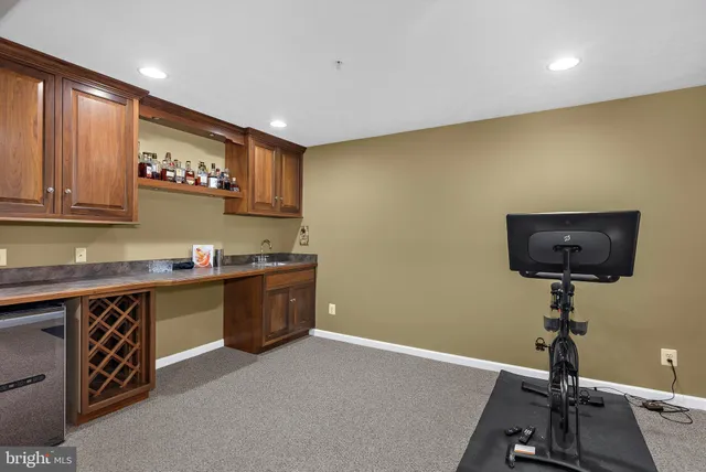 a kitchen with a sink cabinets and wooden floor
