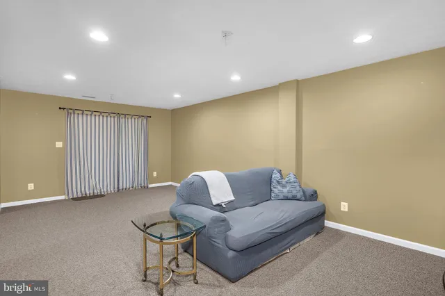 a living room with furniture and a wall painting