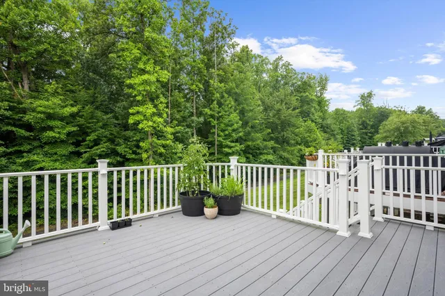 a balcony with wooden floor and fence