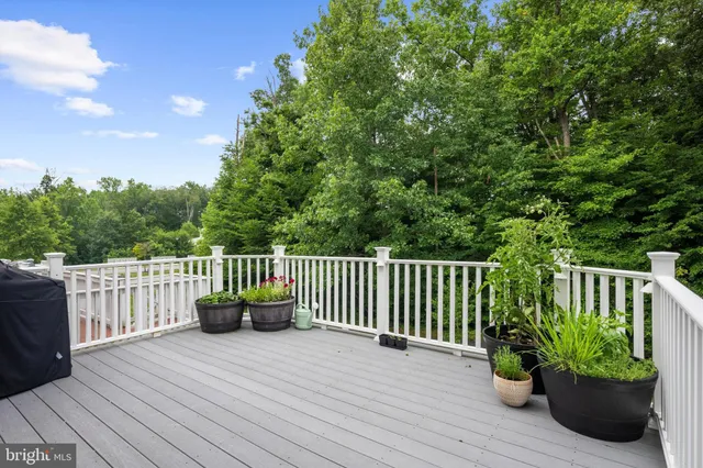a balcony with wooden floor potted plants and wooden floor