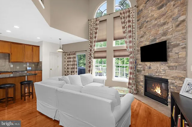 a living room with fireplace furniture and a flat screen tv
