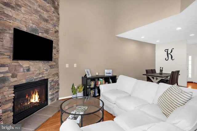 a living room with furniture a fireplace and a flat screen tv