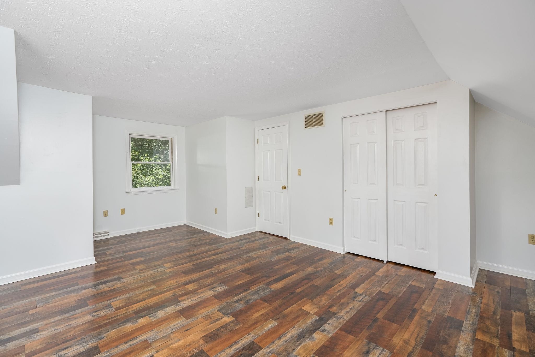 87 Swisher Road Staunton, VA 24401 - Photo 45 of 75 a view of an empty room with wooden floor and a window