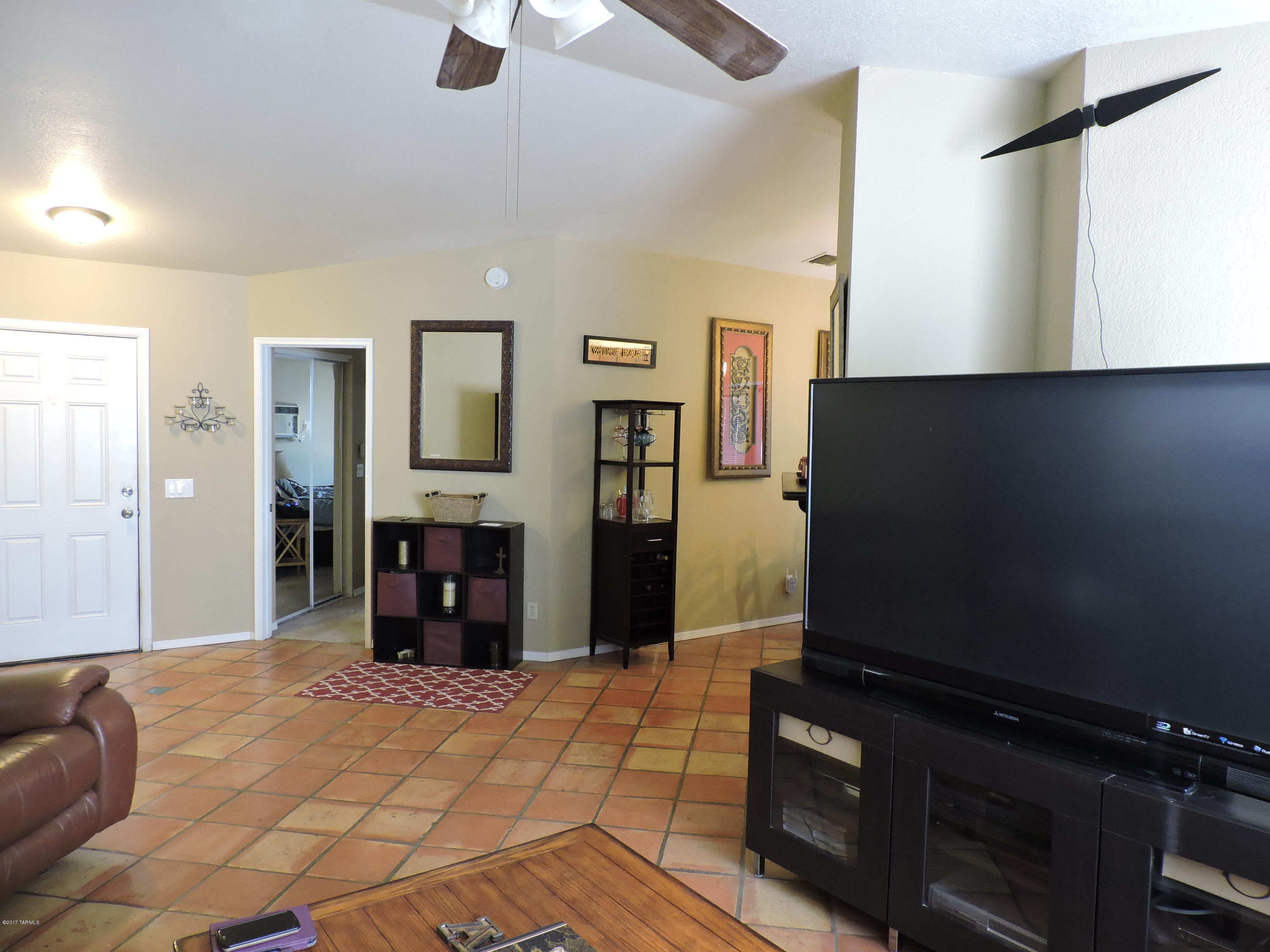 2709 West Firebrook Road Tucson, AZ 85741 - Photo 7 of 17 a bedroom with a bed and a flat tv screen on the dresser