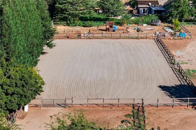 a living room with furniture a flat screen tv and a floor to ceiling window