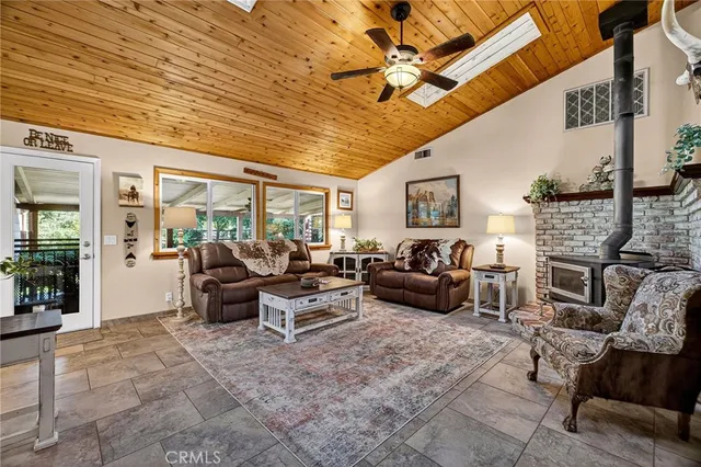 a kitchen with a dining table chairs sink and cabinets
