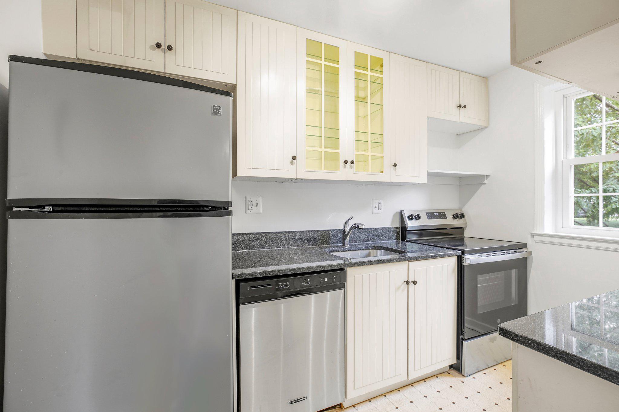 2202 Colston Drive, Unit 102 Silver Spring, MD 20910 - Photo 5 of 38 a kitchen with stainless steel appliances granite countertop a sink stove and cabinets