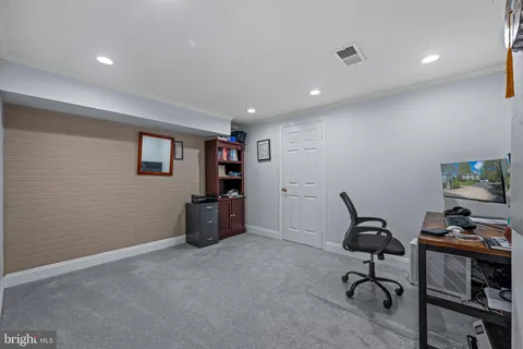 a view of a chair and table in backyard of the house