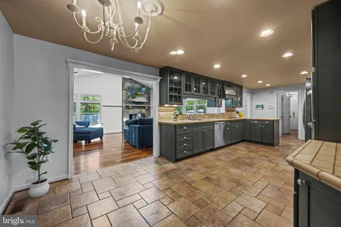 a kitchen with granite countertop a refrigerator and a sink