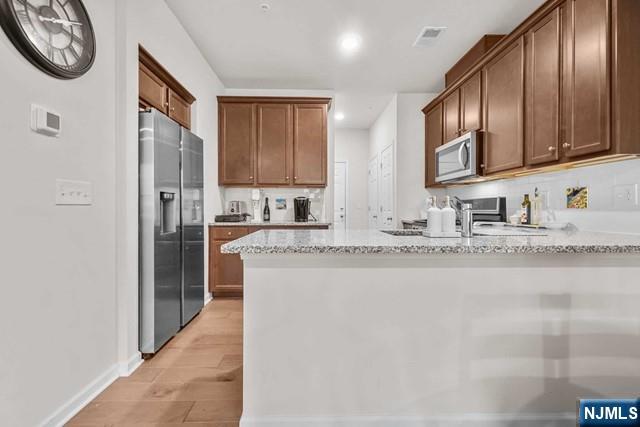 54 Arnold Drive Wood-Ridge, NJ 07075 - Photo 13 of 40 a kitchen with stainless steel appliances granite countertop a refrigerator and a sink