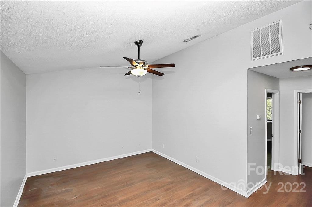 9517 Newell Hickory Grove Road, Unit 4 Charlotte, NC 28215 - Photo 3 of 13 a view of a room with wooden floor and ceiling fan