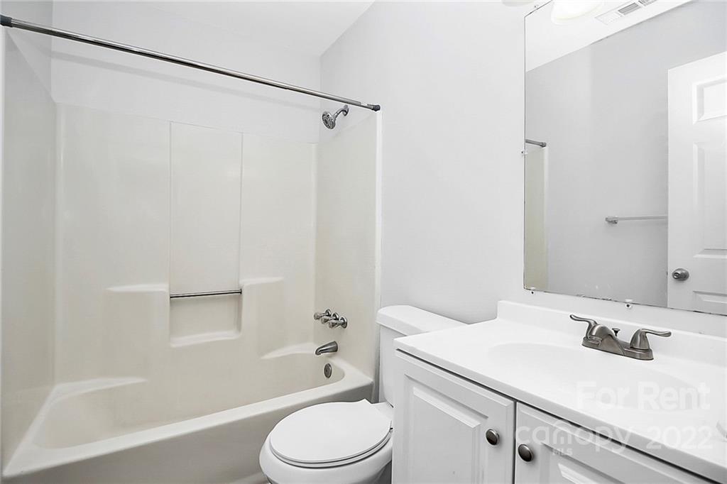 9517 Newell Hickory Grove Road, Unit 4 Charlotte, NC 28215 - Photo 5 of 13 a bathroom with a sink toilet and shower