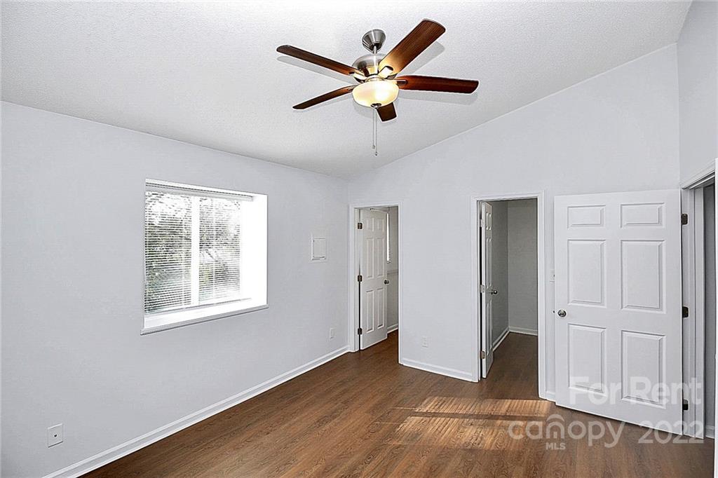 9517 Newell Hickory Grove Road, Unit 4 Charlotte, NC 28215 - Photo 8 of 13 a view of an empty room with wooden floor and a ceiling fan