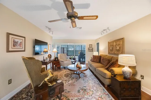 a living room with furniture and a wooden floor