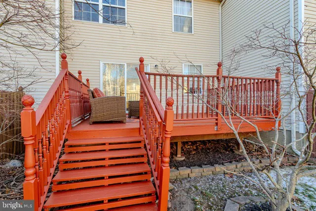 a view of a house with a yard and wooden fence