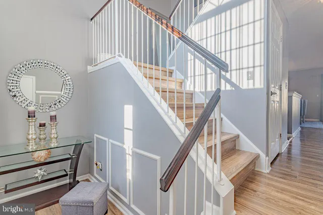 a view of entryway and hall with wooden floor