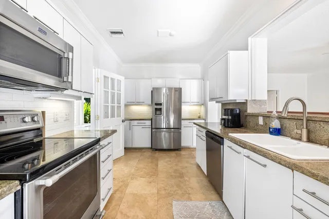a kitchen with a sink appliances and cabinets