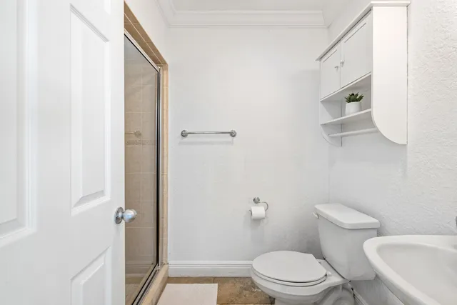 a white toilet sitting next to a bathroom sink