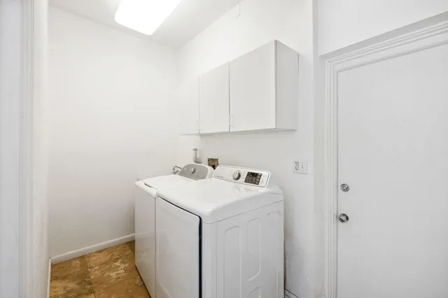 a view of a chairs and table in the backyard