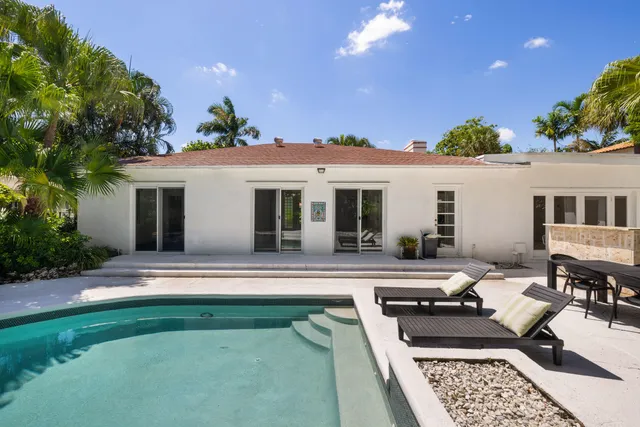 a view of a patio with table and chairs potted plants with large tree