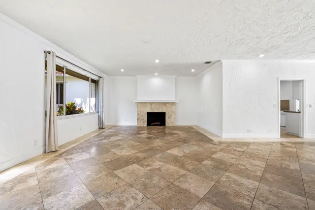 a view of an empty room with a fireplace