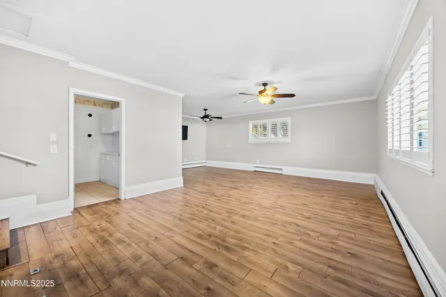 wooden floor in an empty room with a window