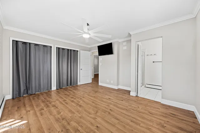 a view of a big room with wooden floor and closet area