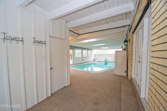 a view of a room with wooden floor and windows