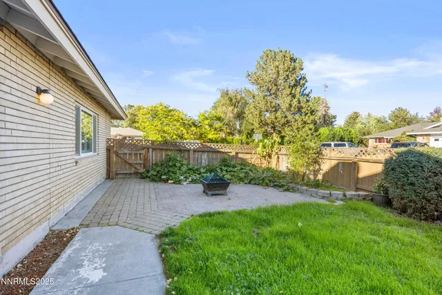 a view of a backyard with sitting area
